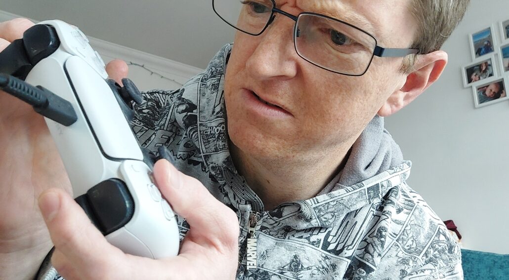 John w Controller A confused John with a PS5 controller